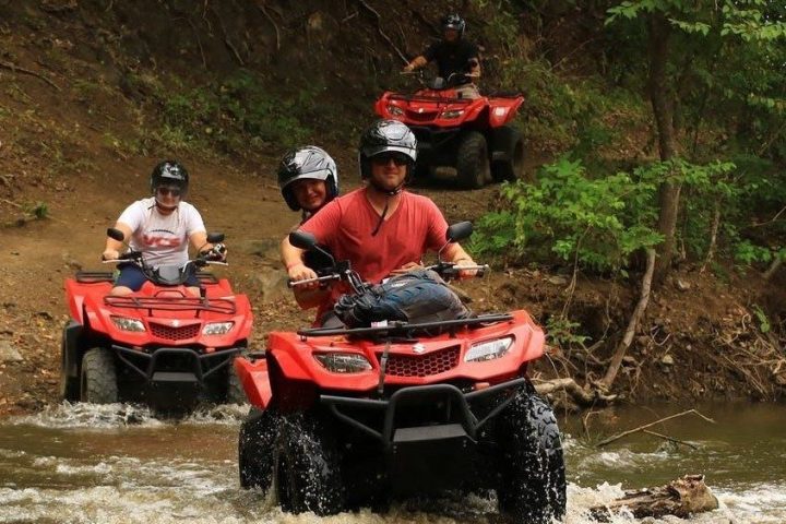 a man riding a motorcycle down a river