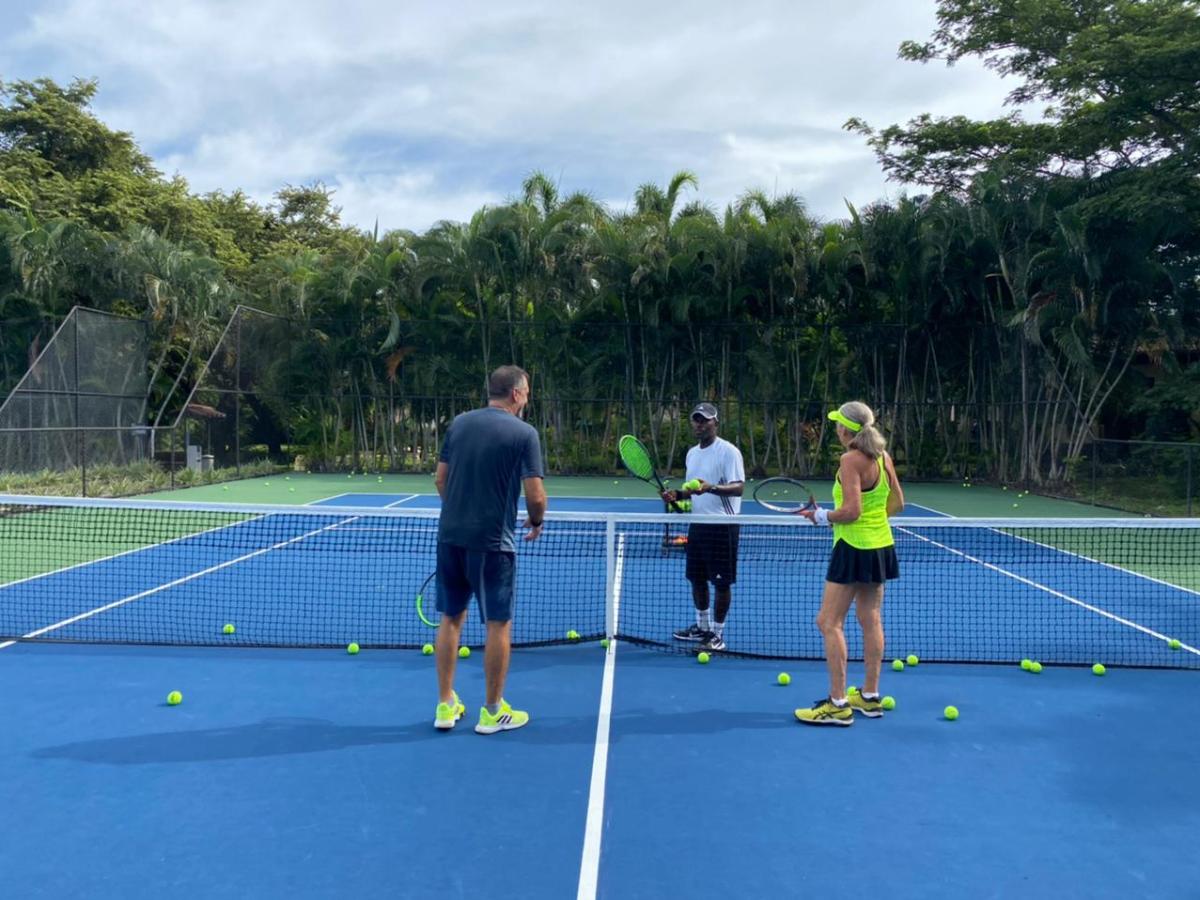 a group of people on a court with a racket