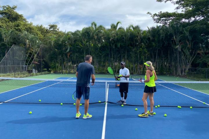 a group of people on a court with a racket