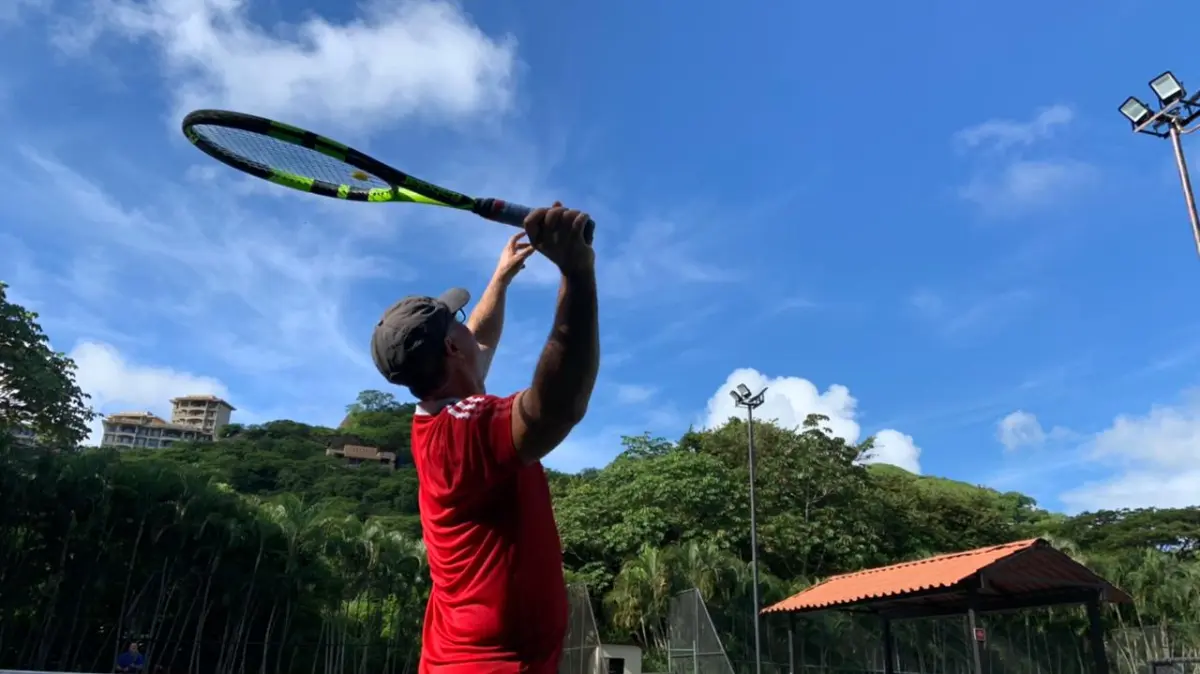 a person hitting a ball with a racket