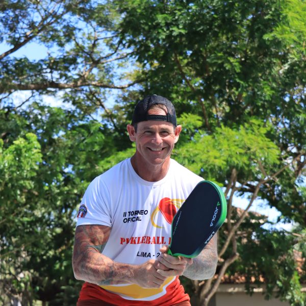 a man holding a frisbee in a park